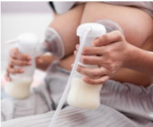 Woman expressing milk using a breast pump