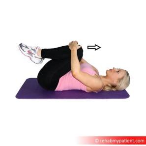Showing double leg knee hug exercise