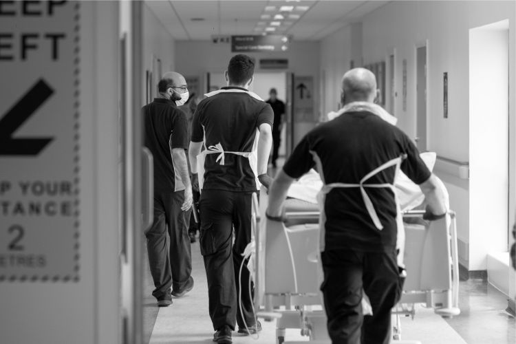 patient being wheeled down a hospital corridor